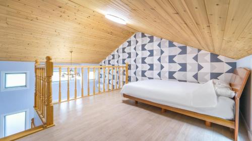a bedroom with a bed with a checkerboard wall at Pocheon Swimpyo Pension in Pocheon