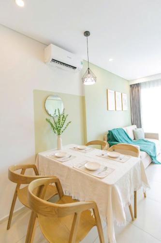 a dining room with a table and chairs at Erica's House - Oceanview The Sóng Apartment Vũng Tàu Nghỉ Dưỡng Biển Cao Cấp 5 Sao - The Song Vung Tau Condotel 5 Star Beach View Apartment in Vung Tau