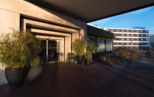 a group of potted plants sitting outside of a building at Wyndham Stuttgart Airport Messe in Stuttgart