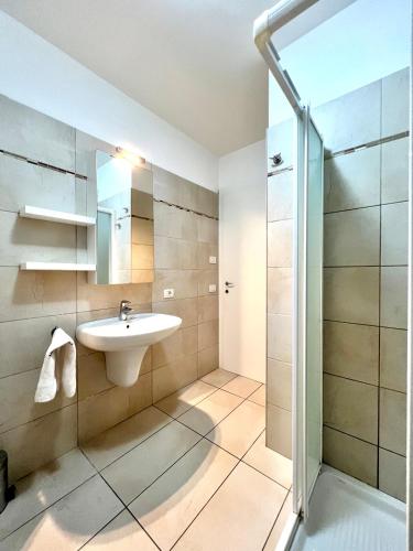a bathroom with a sink and a shower at Garden Thermae in Nago-Torbole