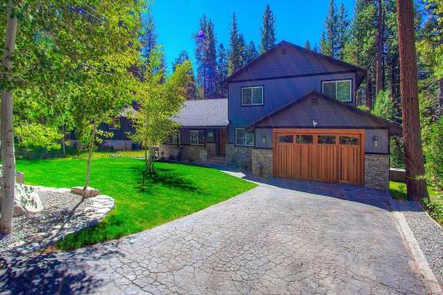 a large house with a garage and a driveway at Creek Side Summit home in Stateline