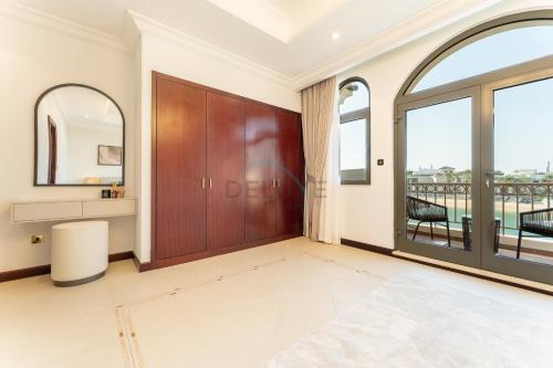 a living room with a sliding door and a balcony at Beachfront 6BR and Assistant's Room Villa with Private Pool, Palm Villa, Palm Jumeirah by Deluxe Holiday Homes in Dubai