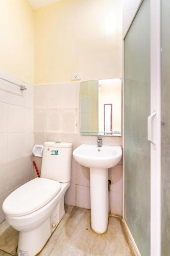 a bathroom with a toilet and a sink at Laciaville Resort and Hotel in Lapu Lapu City