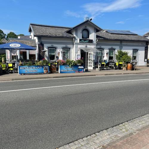 a building on the side of a road with a street at Ellada Restaurant & Hotel in Tarp