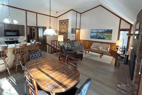 a living room with a wooden table and a kitchen at Brookstone Pines home in Incline Village
