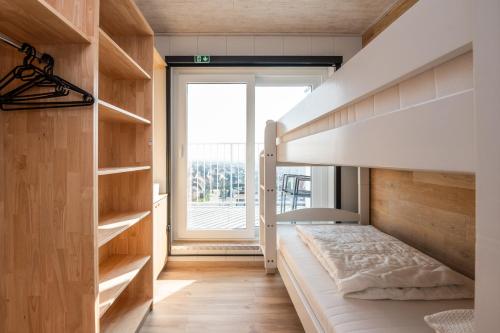 a bedroom with a bed and a large window at Nice apartment with suberb Sea Views in De Haan