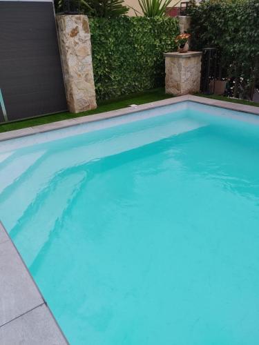 a large swimming pool with blue water at Luxury Villas Chrysa Private Pool & Spa in Nafplio