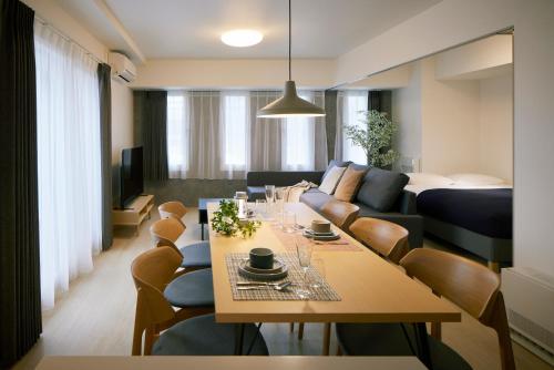 a living room with a table and a couch at Minn Kitahiroshima Station East in Nakanosawa