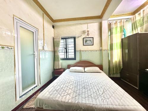 a bedroom with a large bed and a window at My Hao Hotel Ho Chi Minh City in Ho Chi Minh City