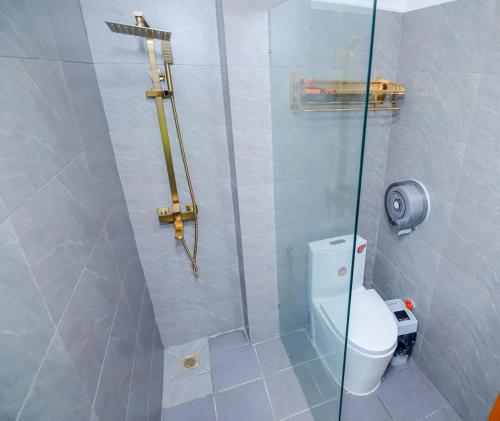 a bathroom with a shower with a toilet at Bliss & Beats Hostel in Phnom Penh
