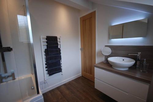a bathroom with a white sink and a shower at The Beeches at Gleneagles in Auchterarder