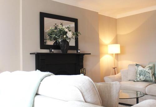 a living room with a couch and a vase of flowers at The Blue Horizon in Cork