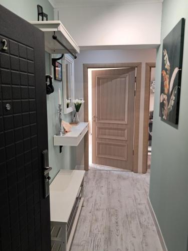 a bathroom with a brown door and a sink at Varna Moreto in Varna City
