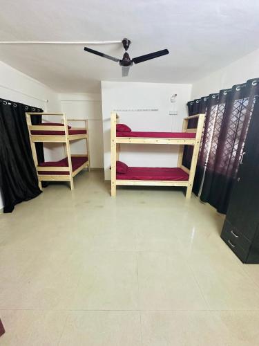 two bunk beds in a room with a ceiling at Alora Homes Ladies Pg in Bengaluru