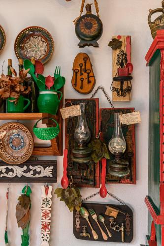 a wall filled with lots of plates and other items at Casa cu Amintiri - Authentic Cozy Cottage in Bran