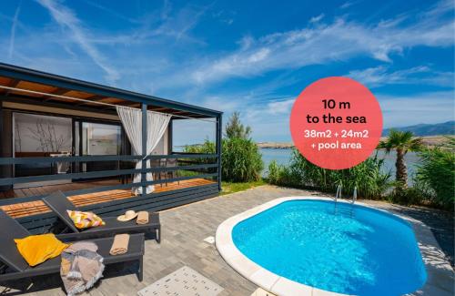 a house with a swimming pool and a sign that reads to the sea at Terra Park SpiritoS in Kolan
