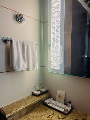 a bathroom with a sink and a shower with a window at Hotel Home In By Amrik Sukhdev in Sonīpat
