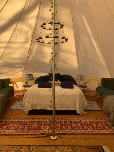 a bedroom with a bed in a tent at North Lodge Glamping in Carnwath