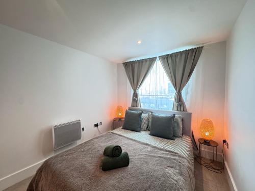 a bedroom with a large bed and a television at River View London Eye Vauxhall 2 Bedroom Apartment in London