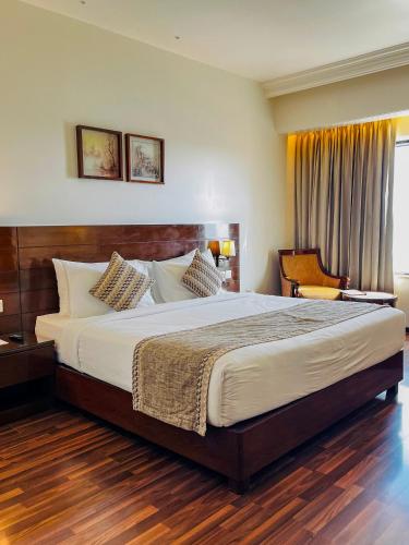 a bedroom with a large bed in a room at Hotel Home In By Amrik Sukhdev in Sonīpat