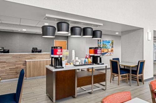 a restaurant with a bar with chairs and aezvousasteryasteryasteryasteryasteryastery at Hampton Inn & Suites Charlotte-Airport in Charlotte