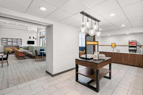 a lobby of a hospital with a table and chairs at Hampton Inn & Suites Charlotte-Airport in Charlotte
