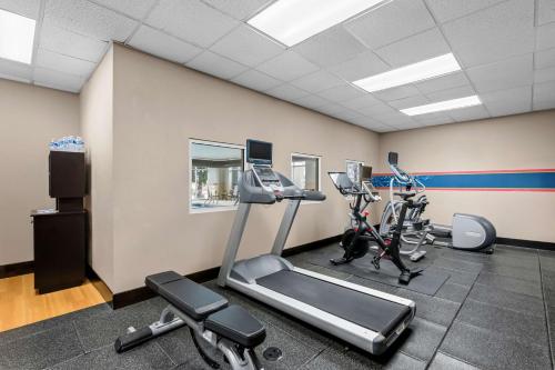 a gym with two exercise bikes and a treadmill at Hampton Inn & Suites Charlotte-Airport in Charlotte