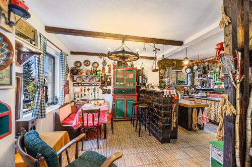 a restaurant with a table and chairs in a room at Casa cu Amintiri - Authentic Cozy Cottage in Bran