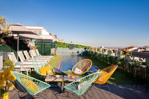 a patio with chairs and a table and a pool at Occidental Diagonal 414 in Barcelona