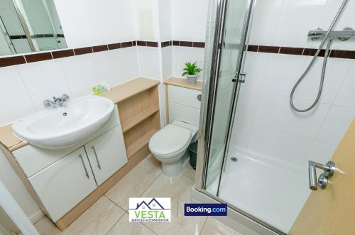a bathroom with a shower and a toilet and a sink at Two Bedrooms Apartment By Vesta Serviced Accommodation & Short Lets Hatfield With Free WiFi in Hatfield