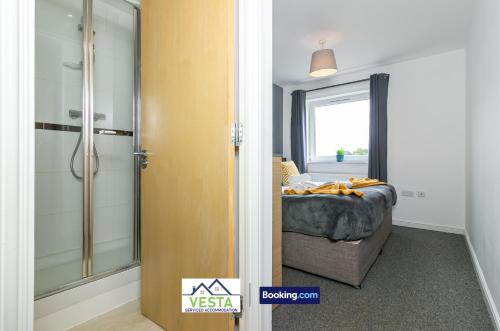 a bedroom with a bed and a glass shower at Two Bedrooms Apartment By Vesta Serviced Accommodation & Short Lets Hatfield With Free WiFi in Hatfield
