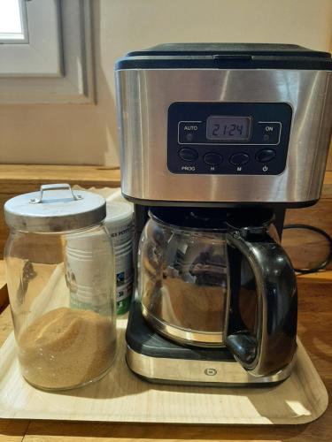 a coffee maker sitting on a counter next to a glass jar at Au cabanon de Lisle in Lisle-sur-Tarn