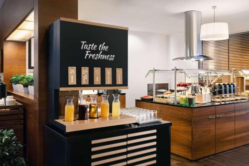 a restaurant with a counter with drinks on it at NH Budapest City in Budapest