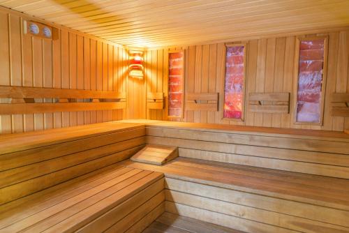 an empty sauna with wood paneling and windows at NH Budapest City in Budapest