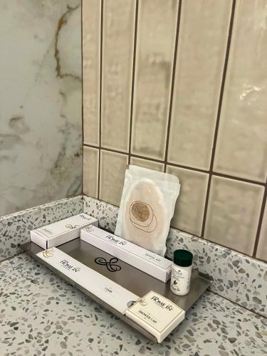 a bathroom counter with a box and a bag of toilet paper at Hotel Home In By Amrik Sukhdev in Sonīpat