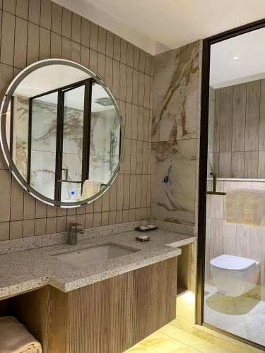 a bathroom with a sink and a mirror at Hotel Home In By Amrik Sukhdev in Sonīpat