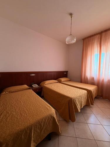 Postel nebo postele na pokoji v ubytování Grifone Hotel