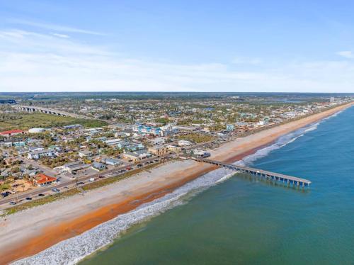 an aerial view of a beach with a pier at Melrose of Flagler Beach in Flagler Beach