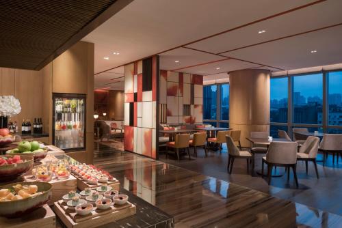 a hotel lobby with a buffet of food and tables at Grand Hyatt Changsha-Close to Helong Sports Center in Changsha