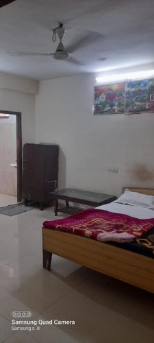 ein Schlafzimmer mit einem Bett und einem Tisch darin in der Unterkunft Hotel Raj Palace in Rewa