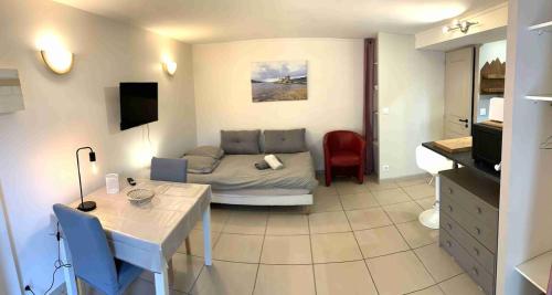 a living room with a couch and a table at Studio SCOTTLAND in Chambéry