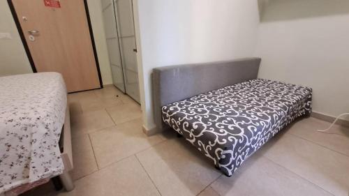 a bedroom with a chair with a patterned cover on it at Guest House Roma Express in Ladispoli