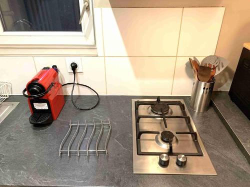 a kitchen counter with a stove top and a blender at Studio SCOTTLAND in Chambéry
