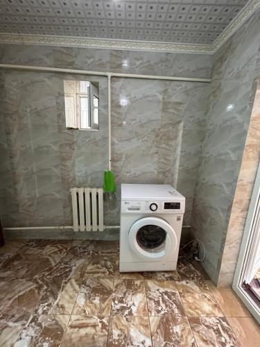 a washer and dryer in a corner of a room at Green Forest guest house in Ivano-Alekseyevka
