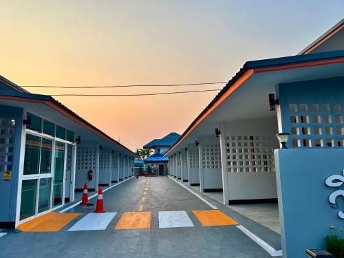 an empty hallway between two buildings with orange cones at V Rich วีริชเพลส ร้อยเอ็ด in Ban Non Muang