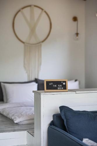 a bedroom with a bed and a clock on a table at Dasi סוויטות אירוח in Moshav Ramot