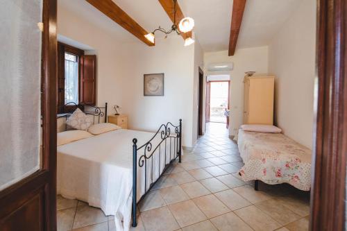 a bedroom with two beds and a hallway at Case vacanze Torrerusso in Casa Pupo