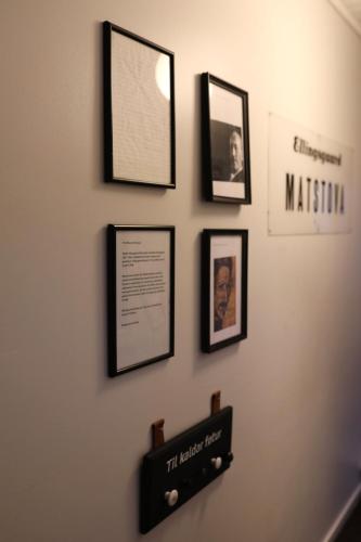a wall with framed pictures on a wall at Historical and cosy house in the heart of Tórshavn in Tórshavn
