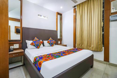 Ένα ή περισσότερα κρεβάτια σε δωμάτιο στο FabHotel Nand