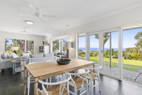 a living room with a table and chairs at Bimbadeen Luxurious Retreat in Aireys Inlet